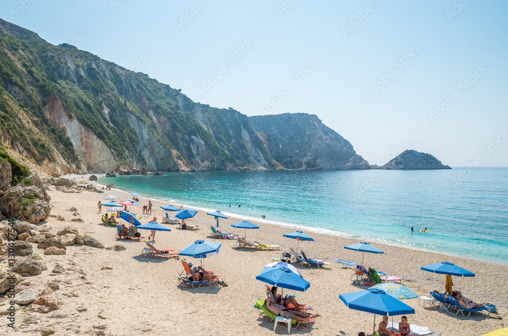 KEFALONIA ISLAND, GREECE - August 8, 2015: People relaxing at the beach of Petani, Kefalonia island, Greece.