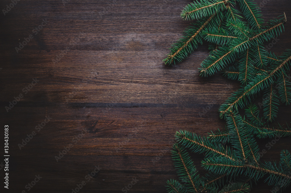 Dark wooden background with fir branches Dark wooden background with fir branches