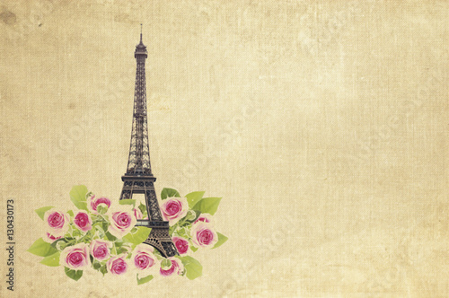 Eifel tower isolated over fabric background with blooming rose flowers. Eiffel Tower from Champ de Mars, Paris, France.