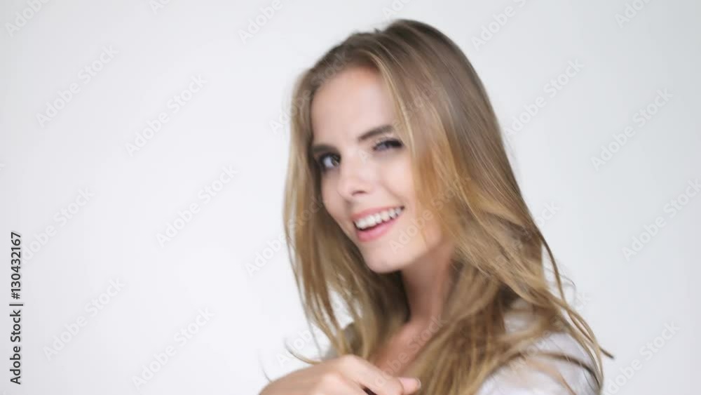 Cheerful young blonde woman in white shirt pointing finger at camera
Cheerful young blonde woman in white shirt pointing finger at camera