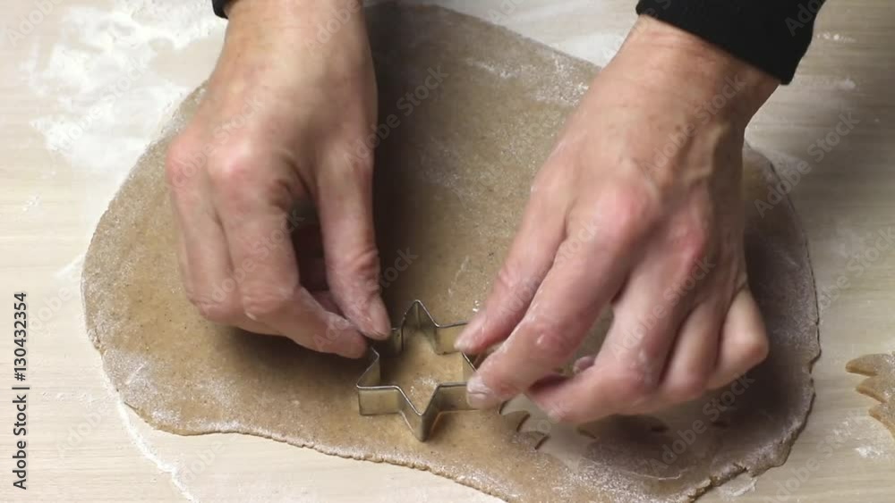 Baking Christmas cookies - Cutting out cookies from rolled out dough Baking Christmas cookies - Cutting out cookies from rolled out dough