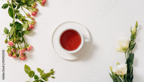 Top view of tea cup surrounded by flowers