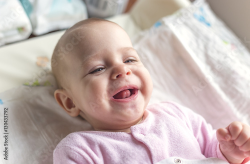 Portrait of a smiling baby laying