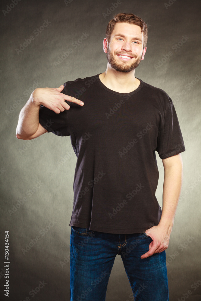 Man guy in blank shirt with copy space pointing. Man guy in blank shirt with copy space pointing.