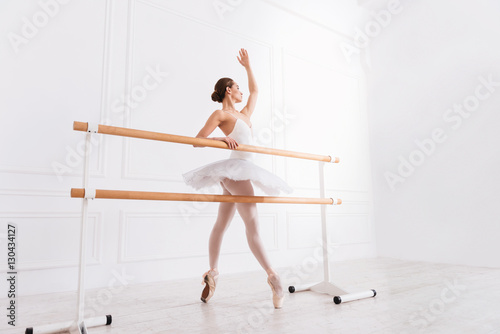 Side view of dancing ballerina in studio