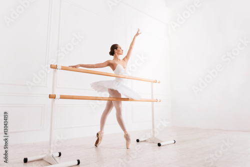 Graceful girl training in ballet class