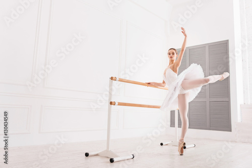 Graceful ballerina doing extension exercises