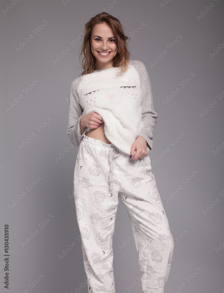Happy teenage girl in funny pajamas on grey background studio. Funky  teenager wearing Pajamas cartoon style Stock Photo | Adobe Stock