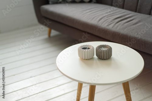 gray sofa in the living room with a coffee table with candles