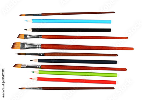 brushes painting and color pencils isolated on white