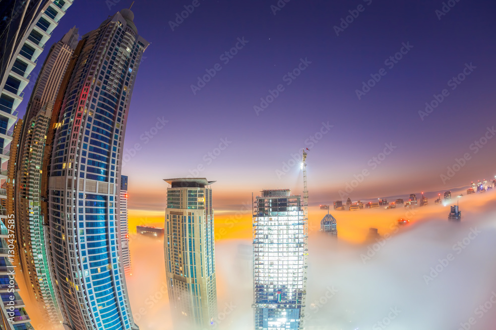 Fototapeta premium Dubai Marina is covered by early morning fog in Dubai, United Arab Emirates