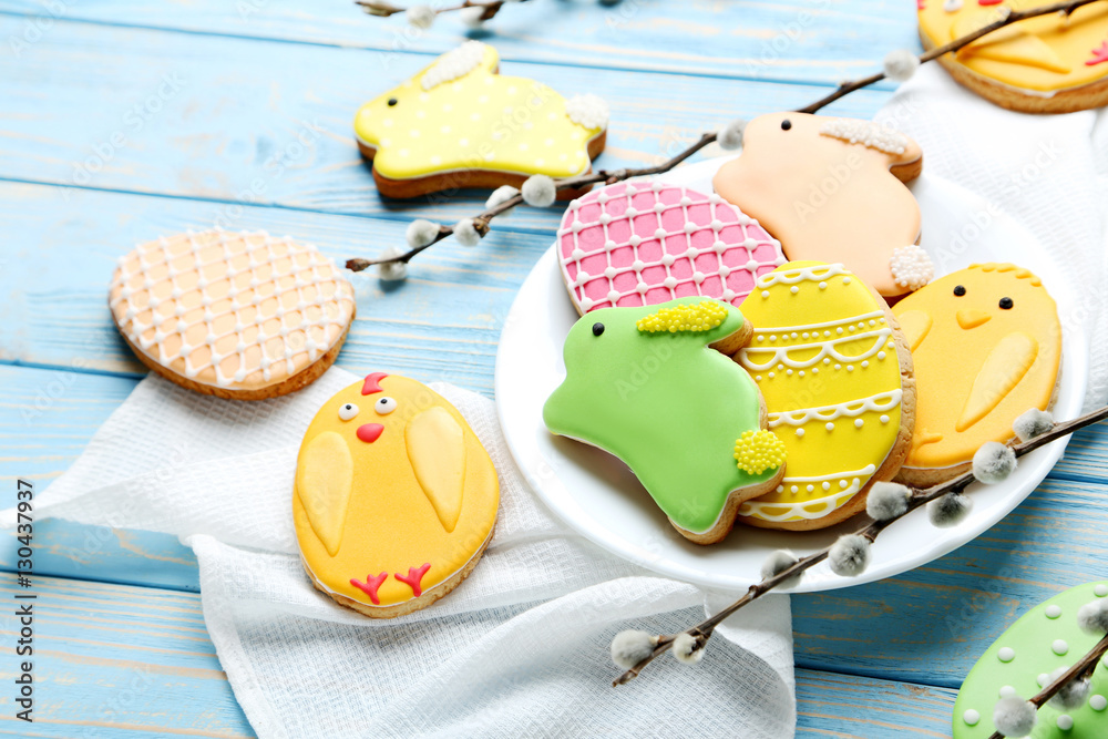 Fototapeta premium Colorful easter cookies on blue wooden background