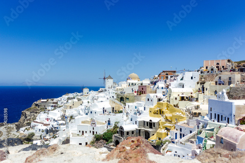 Beautiful view with traditional white buildings over the village of Oia at the Island Santorini, Greece © losbkru