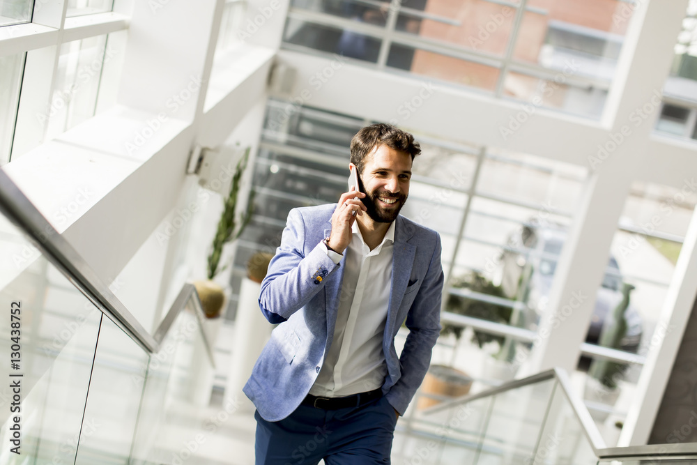 Handsome businessman in suit using the phone Handsome businessman in suit using the phone