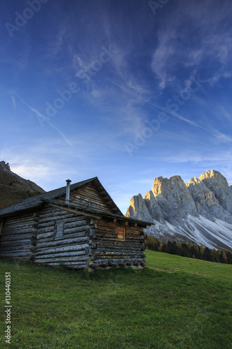 The early morning light illuminates Malga Zannes and the Odle in background, Funes Valley, South Tyrol, Dolomites photo