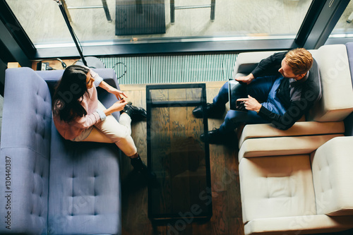 Young modern couple sitting...