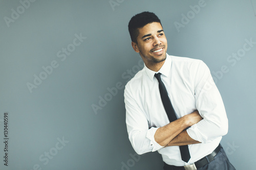 Young black man by the gray wall