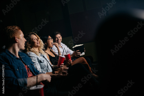 Young people watching movie in multiplex theater