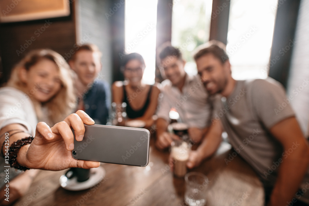 Group of young people taking a selfie at cafe Group of young people taking a selfie at cafe