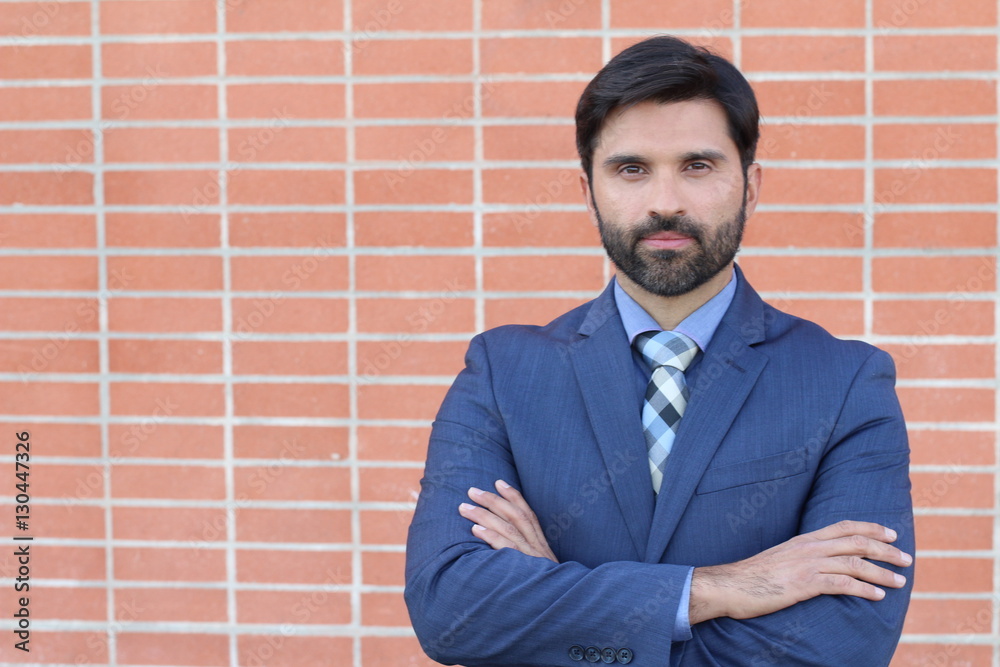 Hispanic good looking executive isolated with arms crossed Hispanic good looking executive isolated with arms crossed