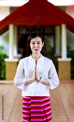 Woman making a Thai Wai salute in Lamphun