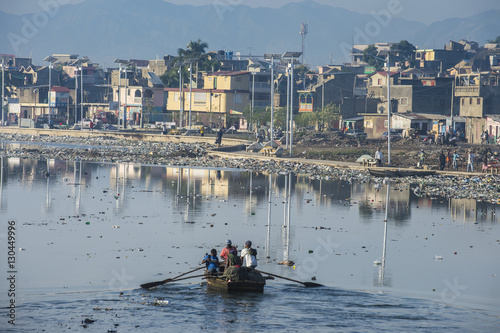 Totally polluted River Mapou flowing through Cap Haitien, Haiti photo