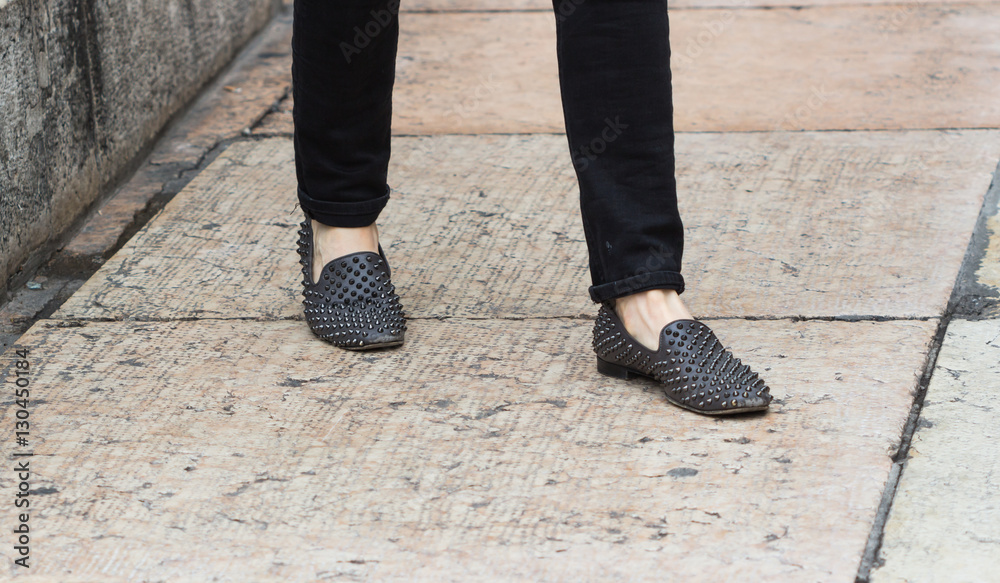 Young fashion legs in black jeans and black boots detail on street floor / New fashion Young fashion legs in black jeans and black boots detail on street floor / New fashion