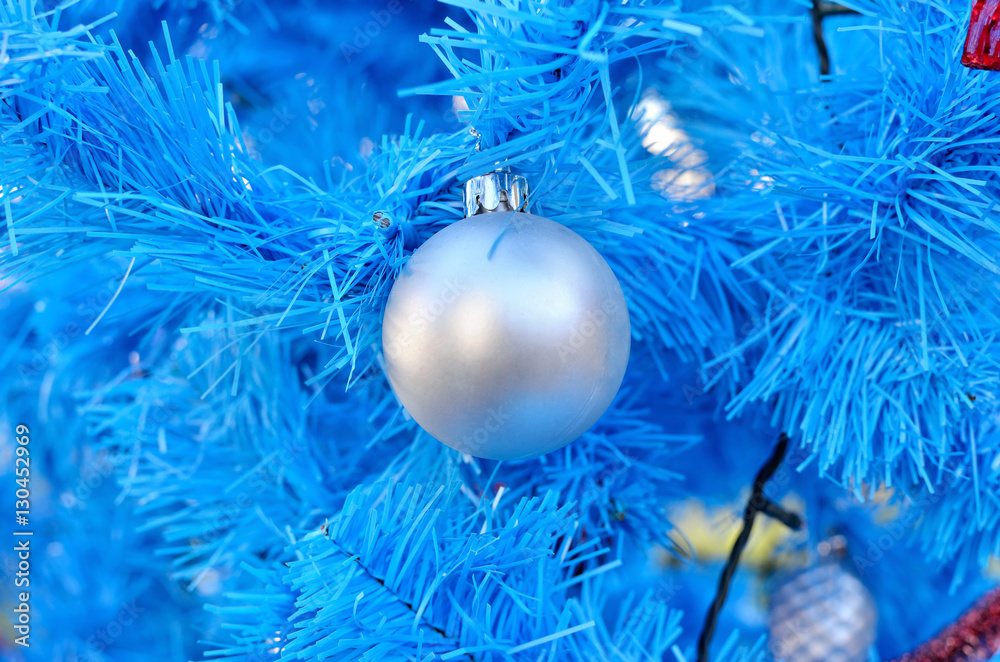Blue branches of the Christmas tree decorated with toys. New Year decoration.