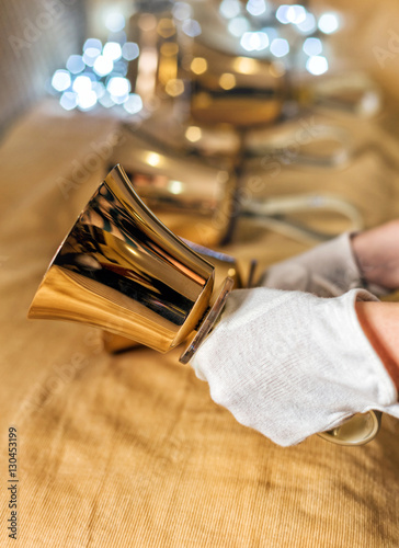 Close-up of girl holding metal bell in hand