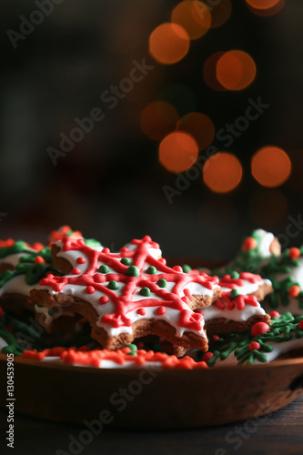 Xmas composition. Gingerbread cookies in the shape of snowflakes in a copper bowl on a dark bokeh background. 