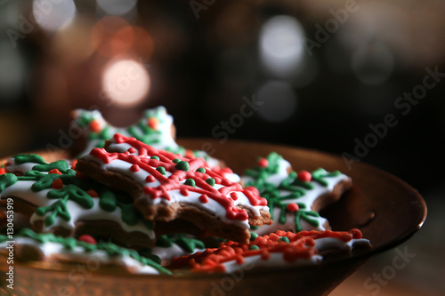 Xmas composition. Gingerbread cookies in the shape of snowflakes in a copper bowl on a dark bokeh background. 