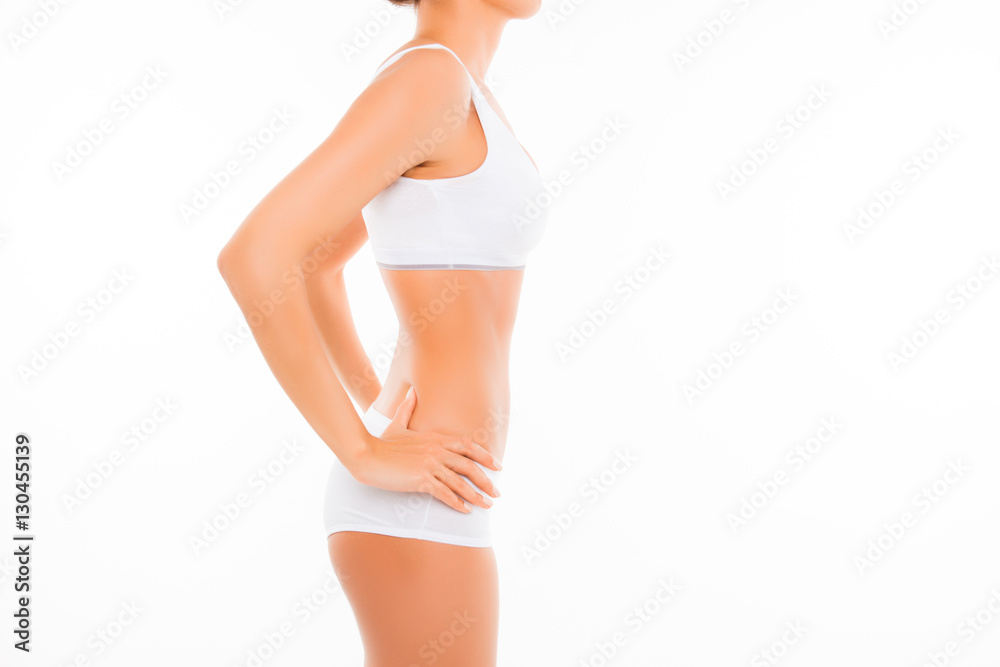 Side view of slim  woman in lingerie on white background