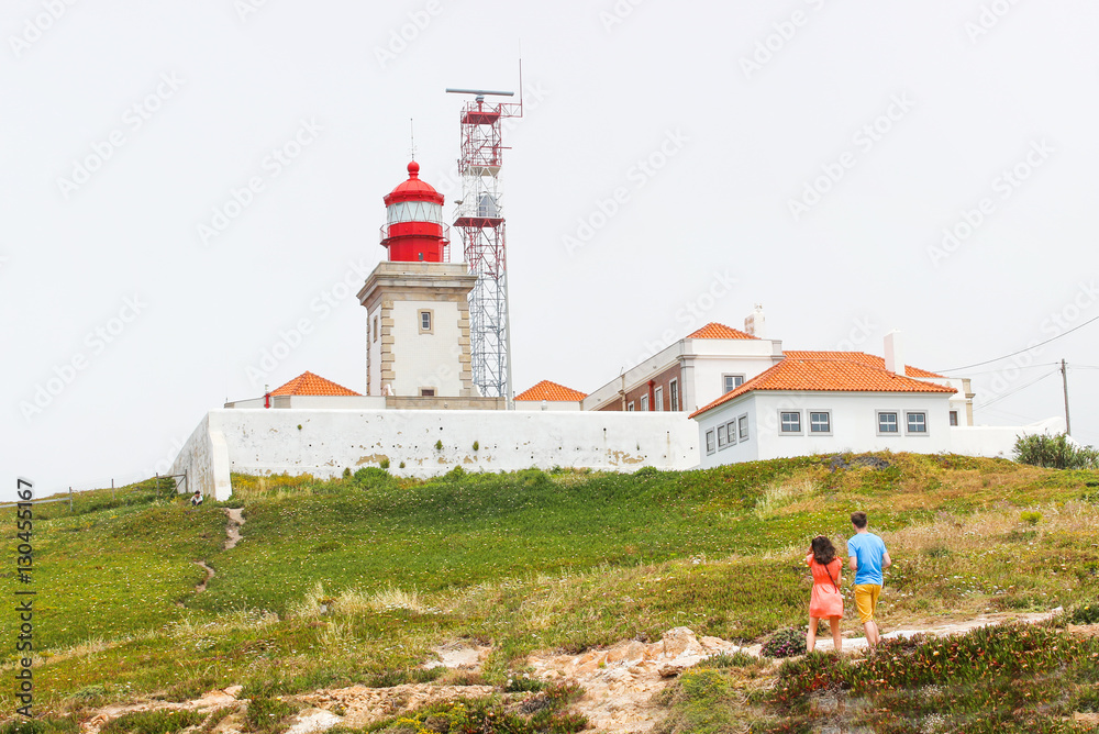 Lighthouse with tourist couple background.