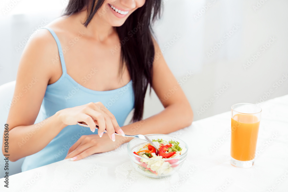 Close up of happy woman eating fresh vegetable salad Close up of happy woman eating fresh vegetable salad