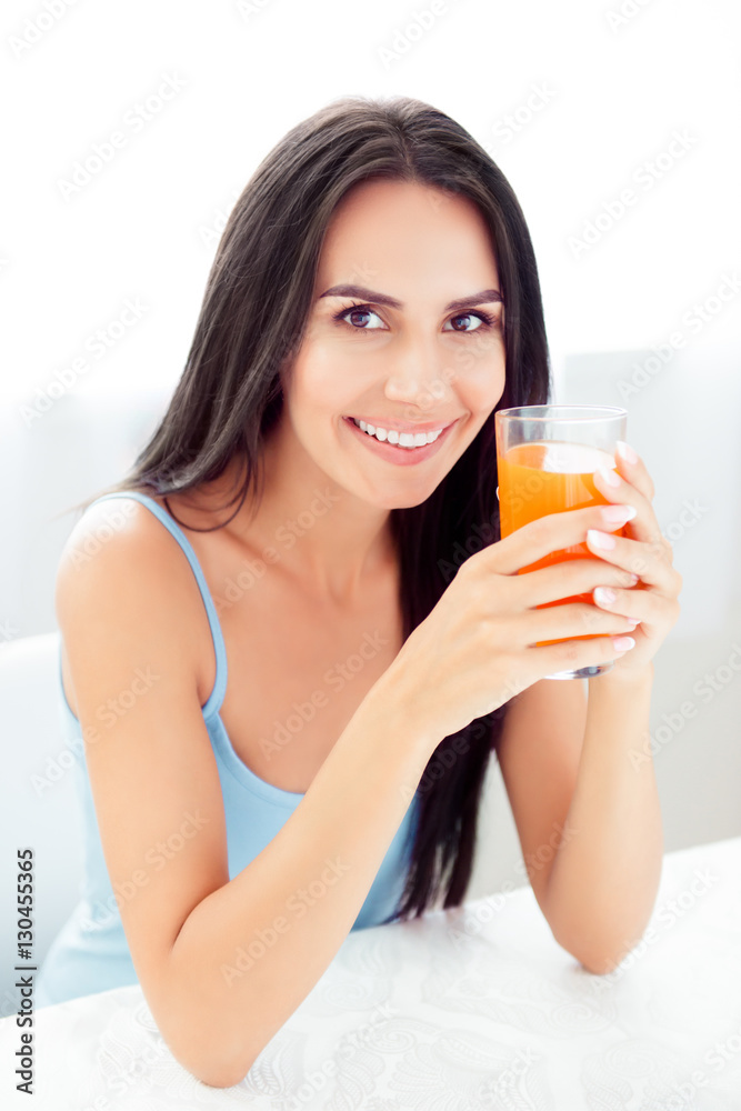 Young beautiful woman holding glass of orange juice Young beautiful woman holding glass of orange juice