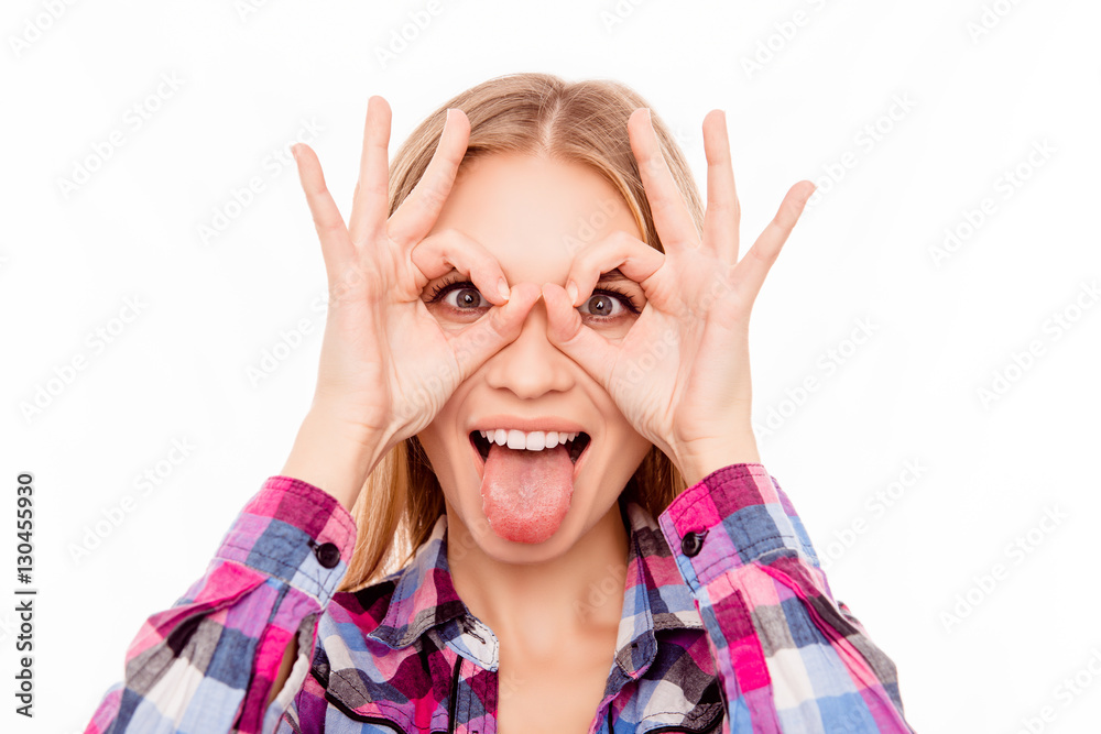 Comic happy woman making glasses with fingers and showing tongue Comic happy woman making glasses with fingers and showing tongue