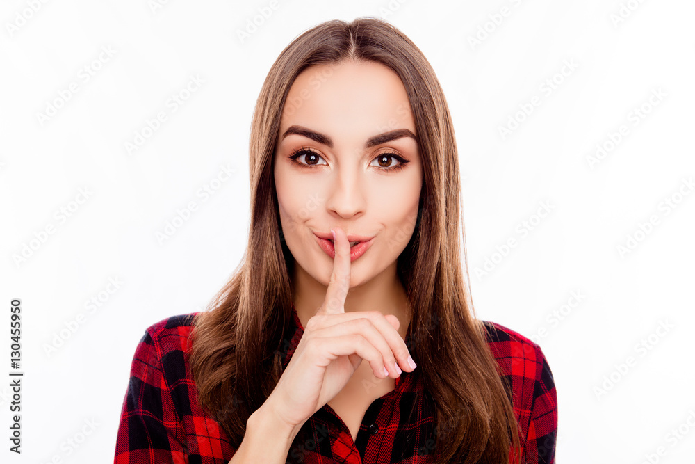 Pretty woman in red checkered shirt showing silent gesture Pretty woman in red checkered shirt showing silent gesture