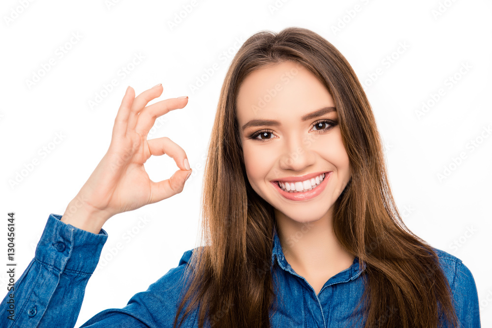 Portrait of cheerful happy brunette woman showing ok gesture Portrait of cheerful happy brunette woman showing ok gesture