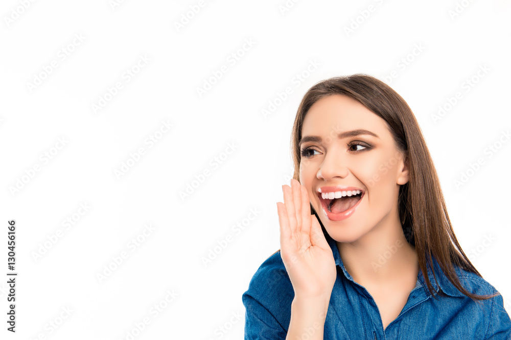 Cheerful happy pretty girl telling secret on white background Cheerful happy pretty girl telling secret on white background