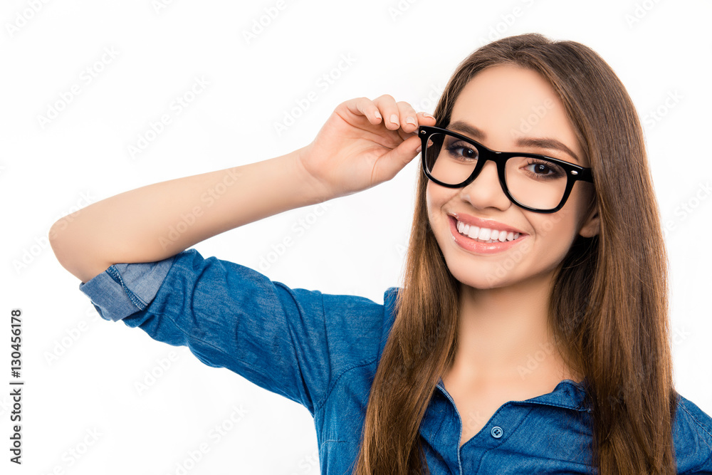 Portrait of pretty young happy woman touching glasses
