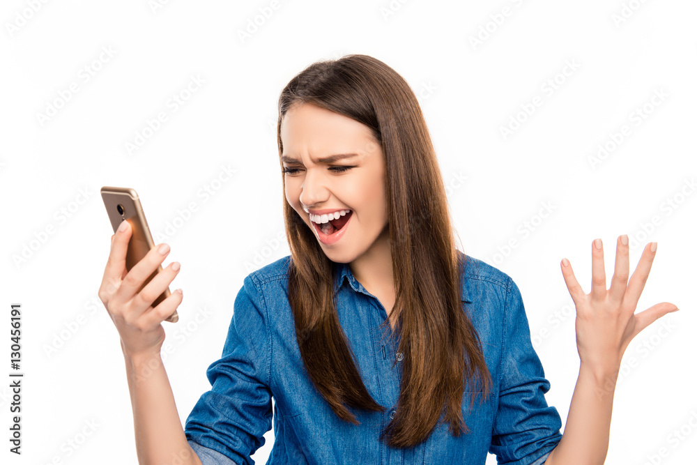 Shocked frustrated young woman reading sms and screamind Shocked frustrated young woman reading sms and screamind