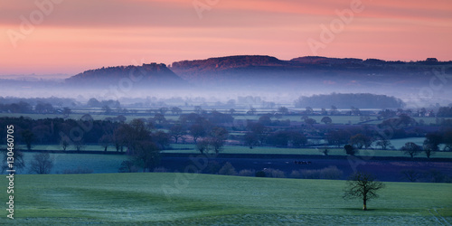 Dawn illuminates Beeston and Peckforton castles on the Peckforton sandstone ridge with mist lying on the Cheshire plain below, Cheshire photo