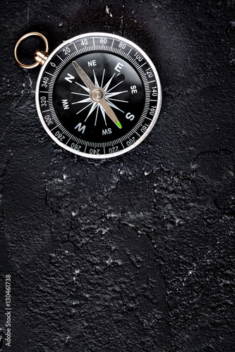 compass on dark background concept - direction motion top view