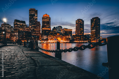 Boston downtown skyline with skyscrapers over water at twilight