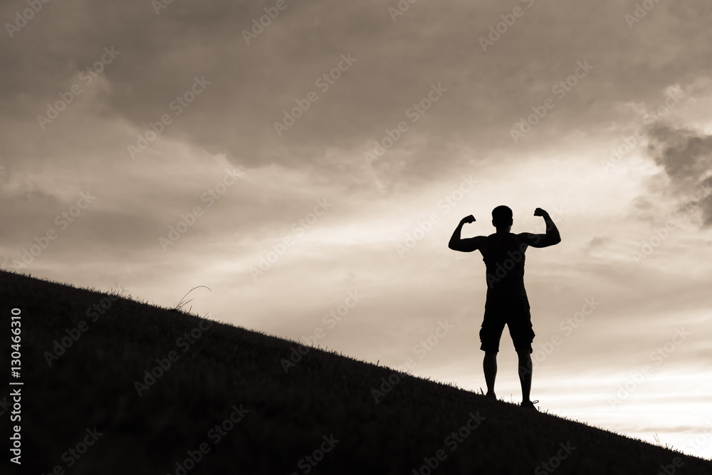 Strong and confident man flexing his muscles. Success and life goals concept. 