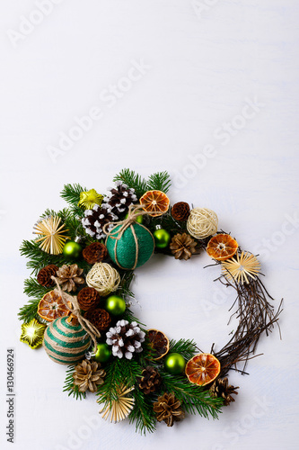 Christmas wreath with fir branches, green balls and rustic ornam