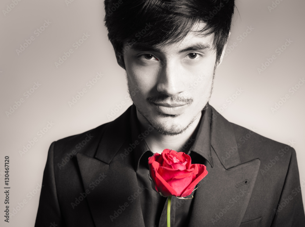 Handsome man holding a single red rose. Romantic valentines gift concept. Handsome man holding a single red rose. Romantic valentines gift concept.