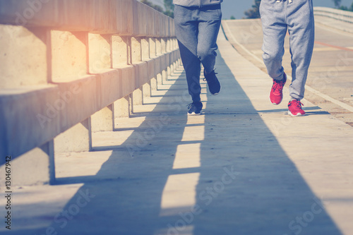 two young people running together on road. Man and woman jogging