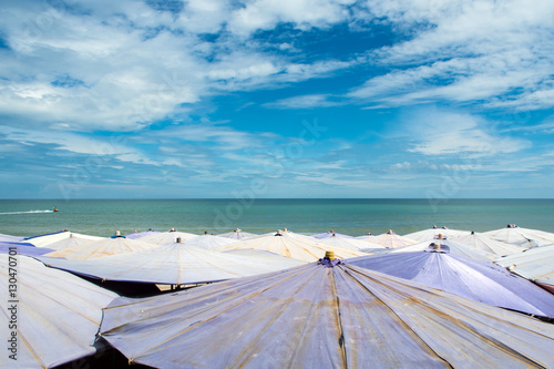 Large umbrella crowded along Cha-Am beach