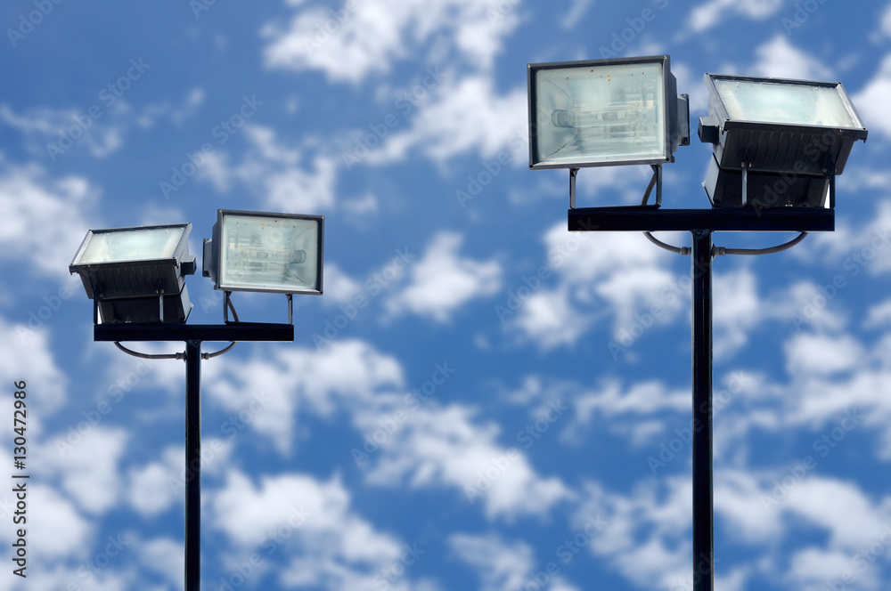 Spotlight pole on daylight blue sky with clouds Spotlight pole on daylight blue sky with clouds